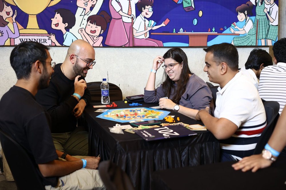 Attendees at a Meeplecon game table